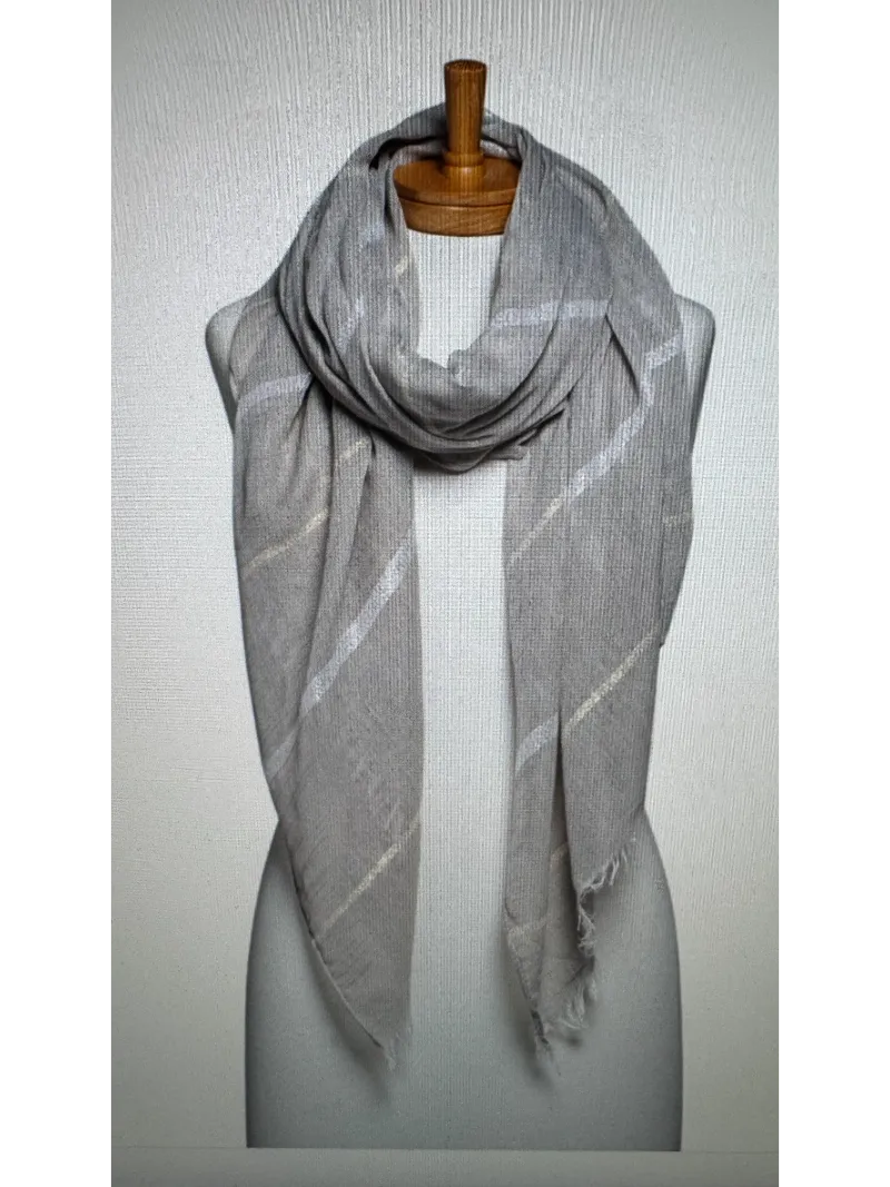 A grey scarf with a lurex stripe on a mannequin body tied in a front roll knot
